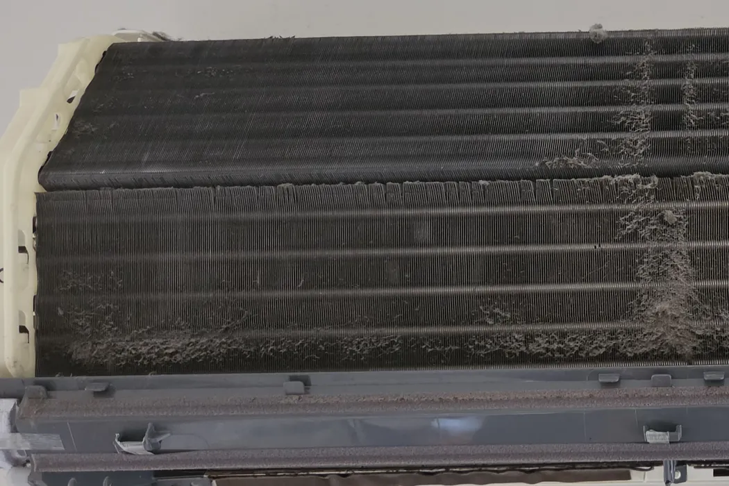 Mini-split coil felted with grey dust between the fins before cleaning