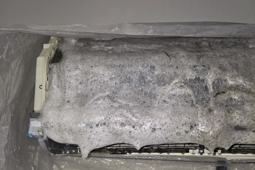 The same coil under grey cleaning foam, the head wrapped in a wash bag