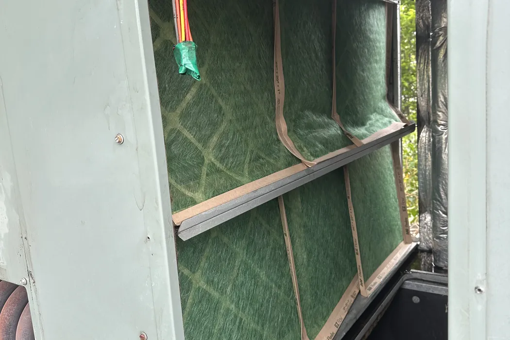 New filter being fitted into an open filter rack