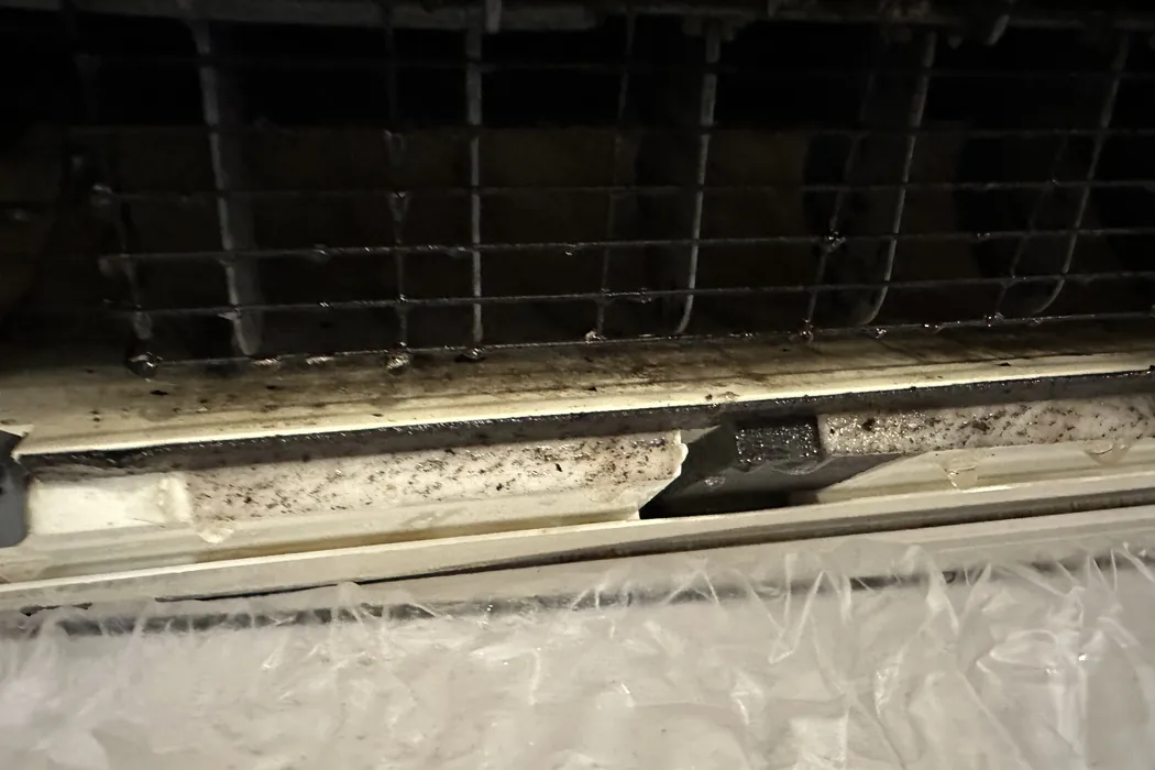 Drain pan and blower of a mini-split before cleaning