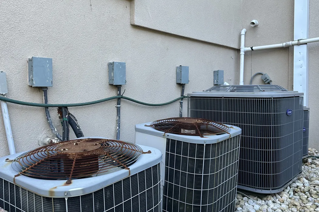 Bank of outdoor condenser units serving a multi-zone system