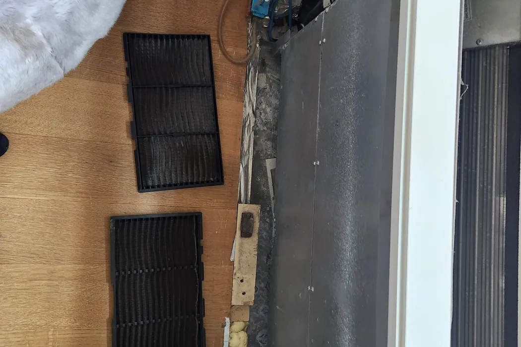 Fan coil unit reassembled under its ceiling panel