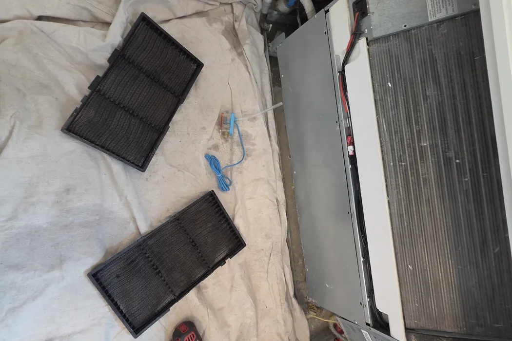 Fan coil filters removed and laid out on a drop cloth